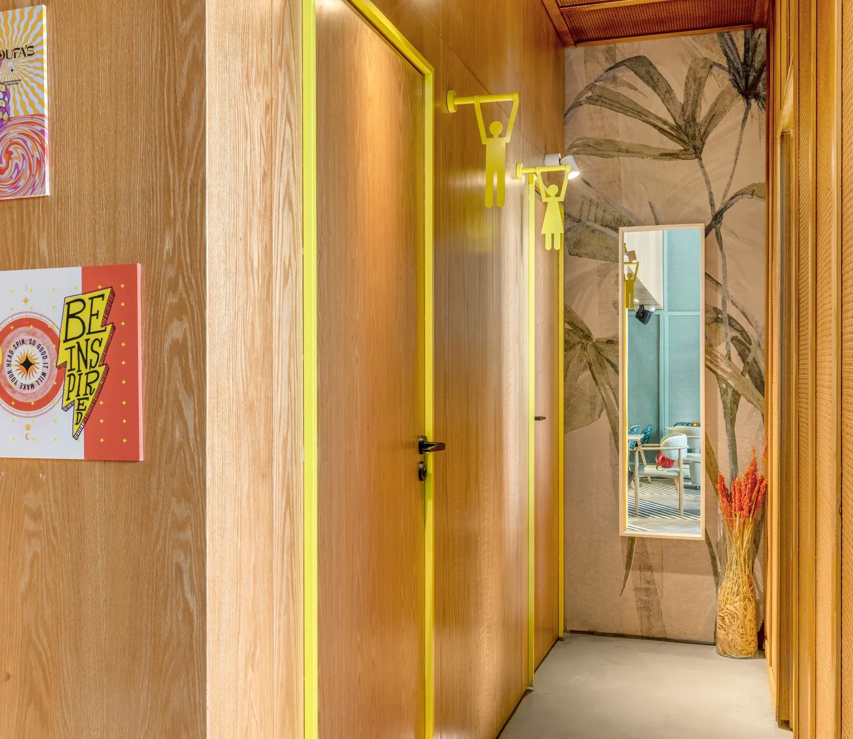 Timber-panelled corridor with yellow trim and tropical wallpaper