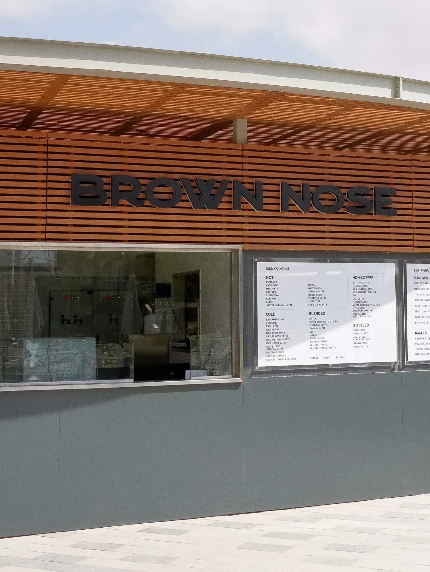 Service window and menu boards below the slatted roof