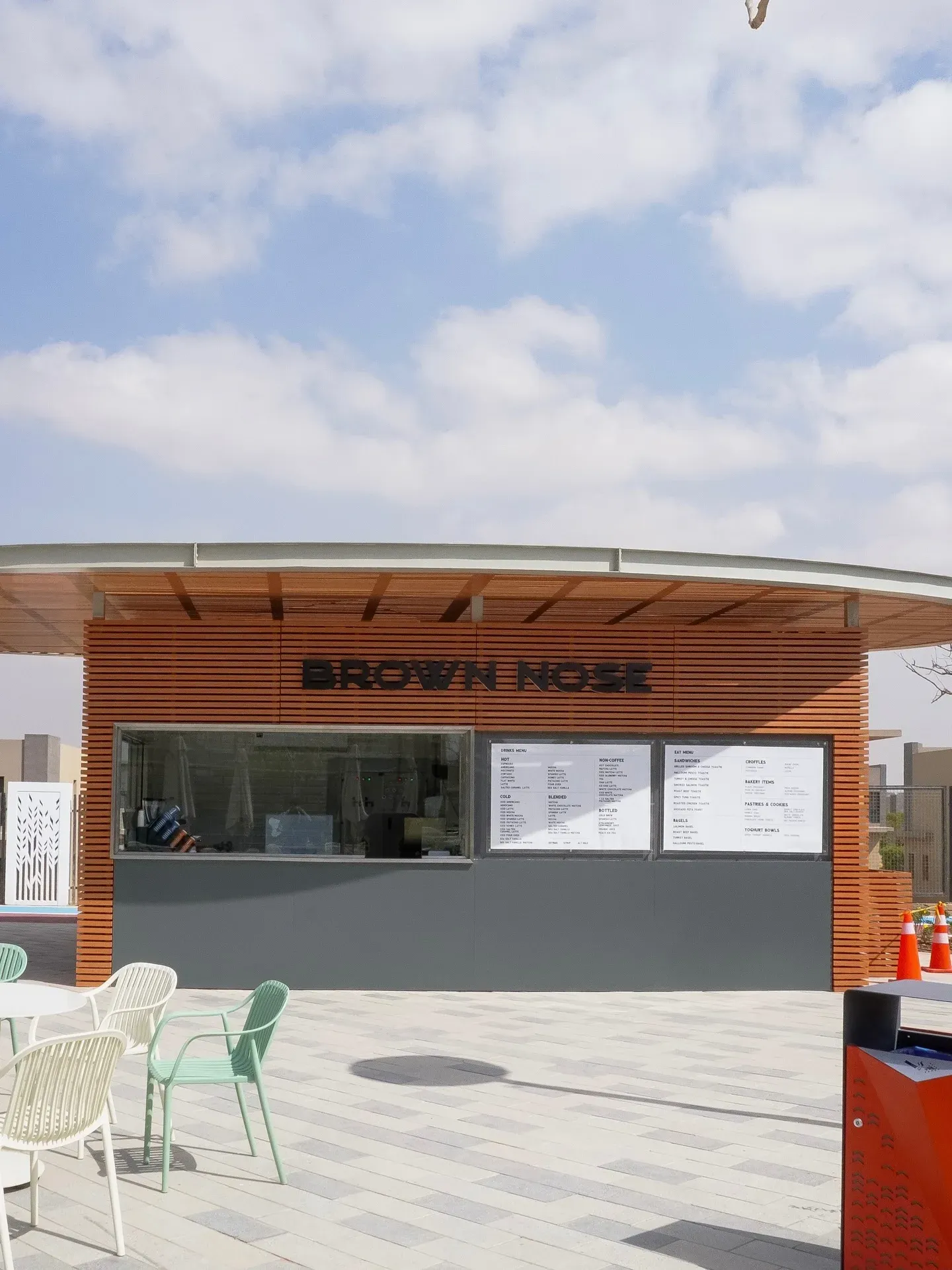 Kiosk front with outdoor chairs on the paved terrace