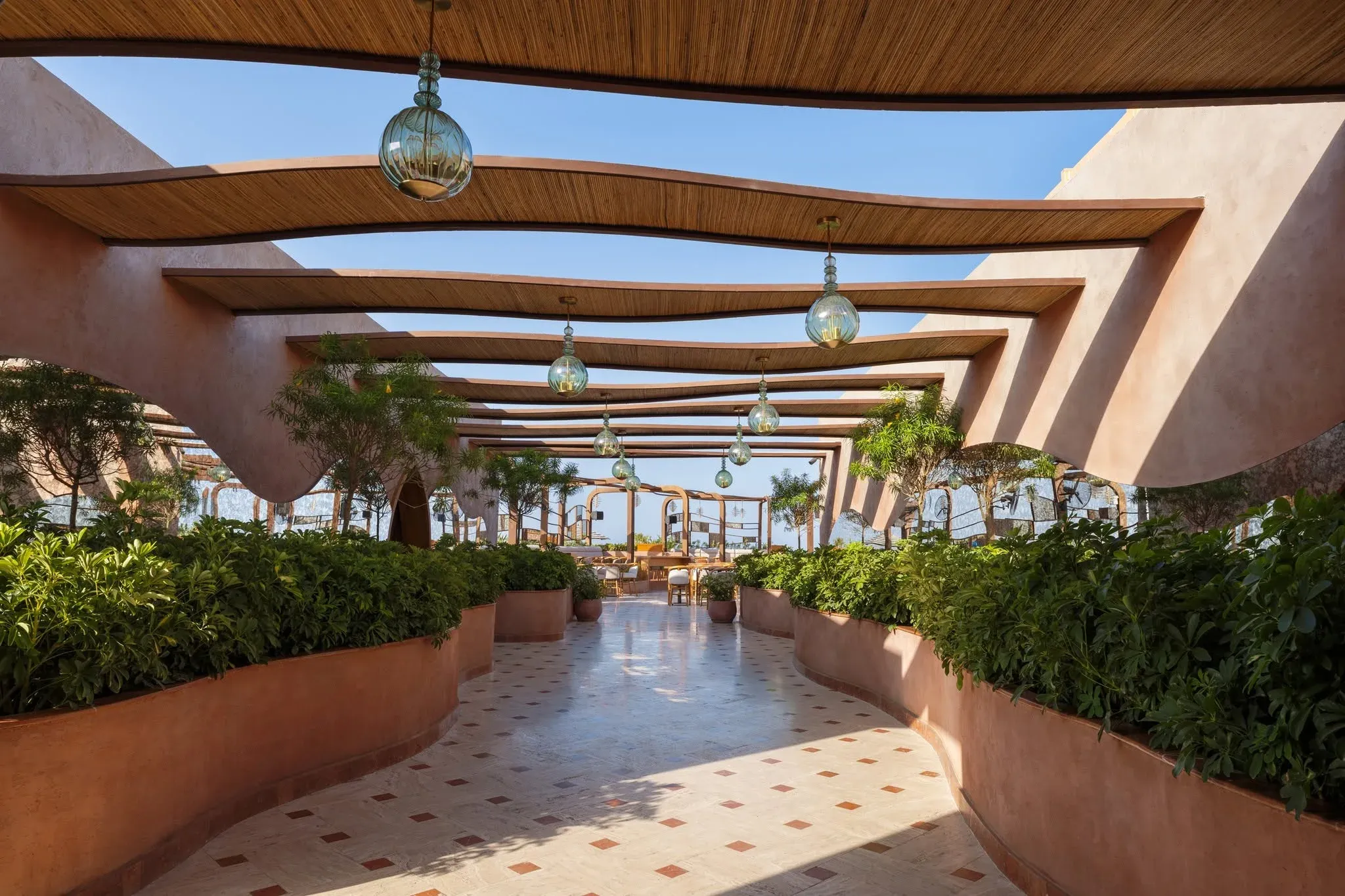 Walkway beneath the canopy towards the terrace, planters on both sides