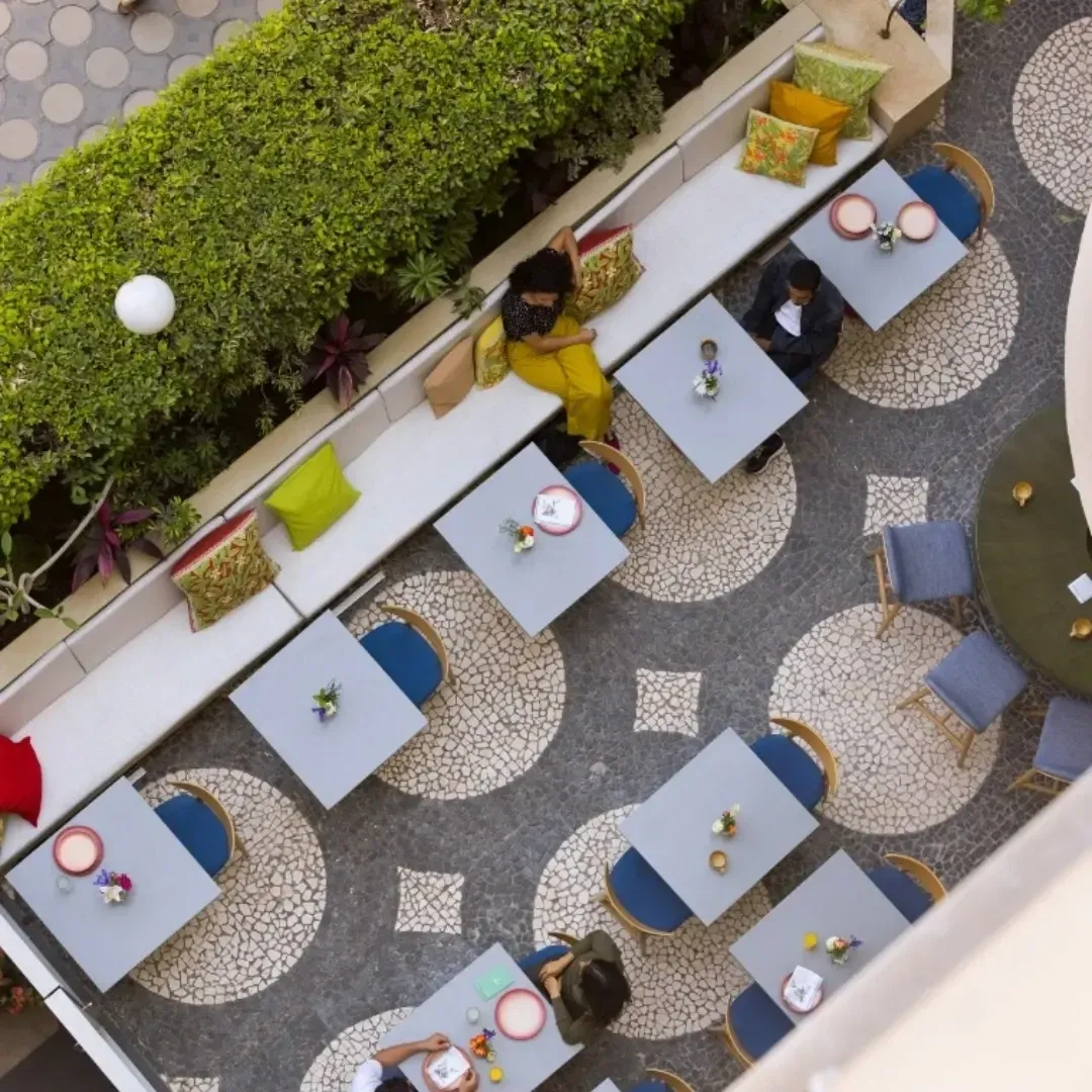Overhead view of tables and banquette on mosaic paving