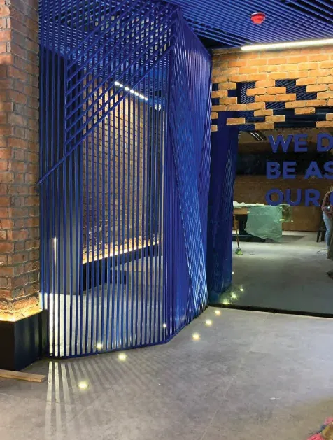 Blue slatted screen and brick-pattern ceiling detail