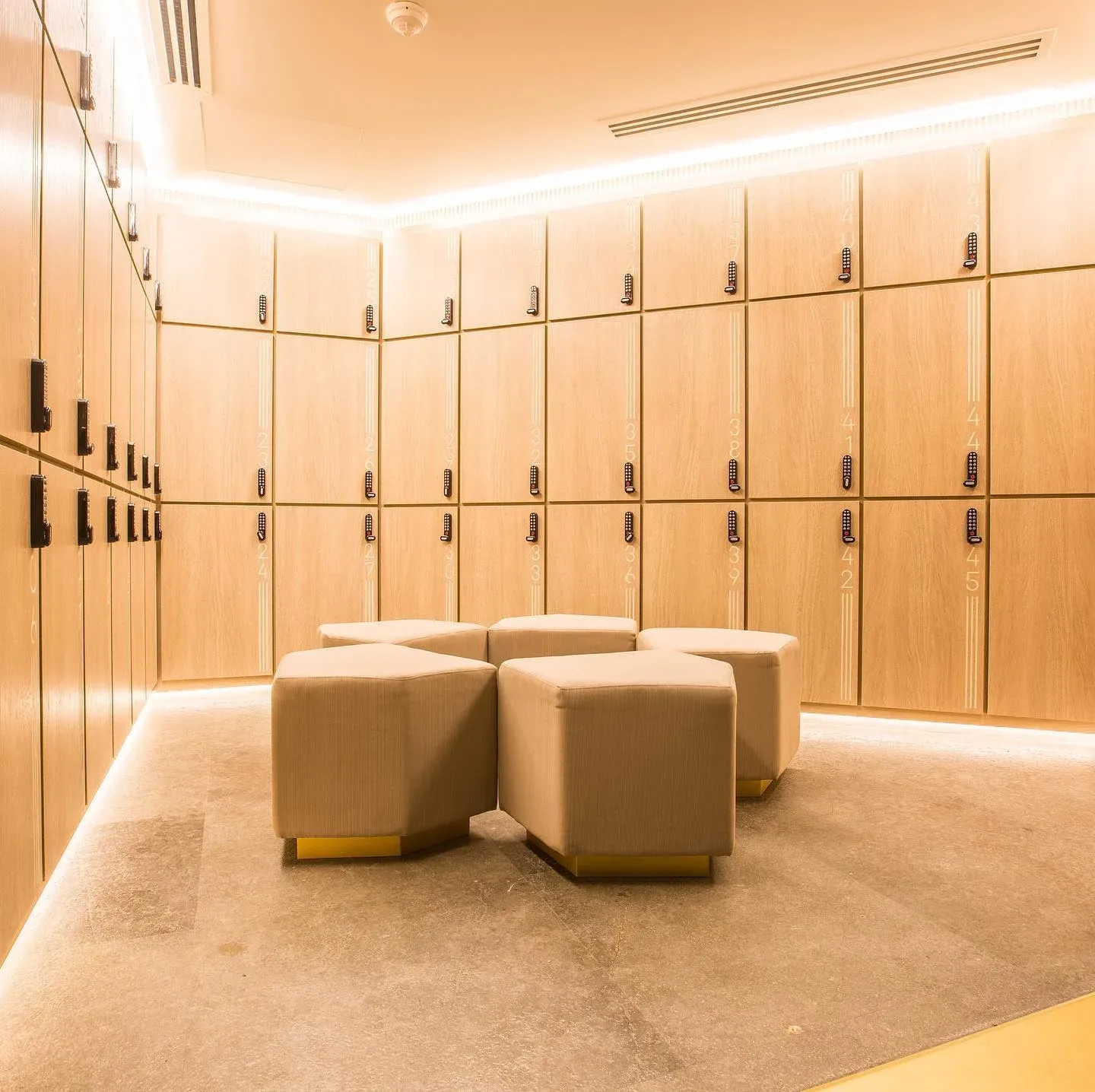 Timber lockers and hexagonal stools in the changing room