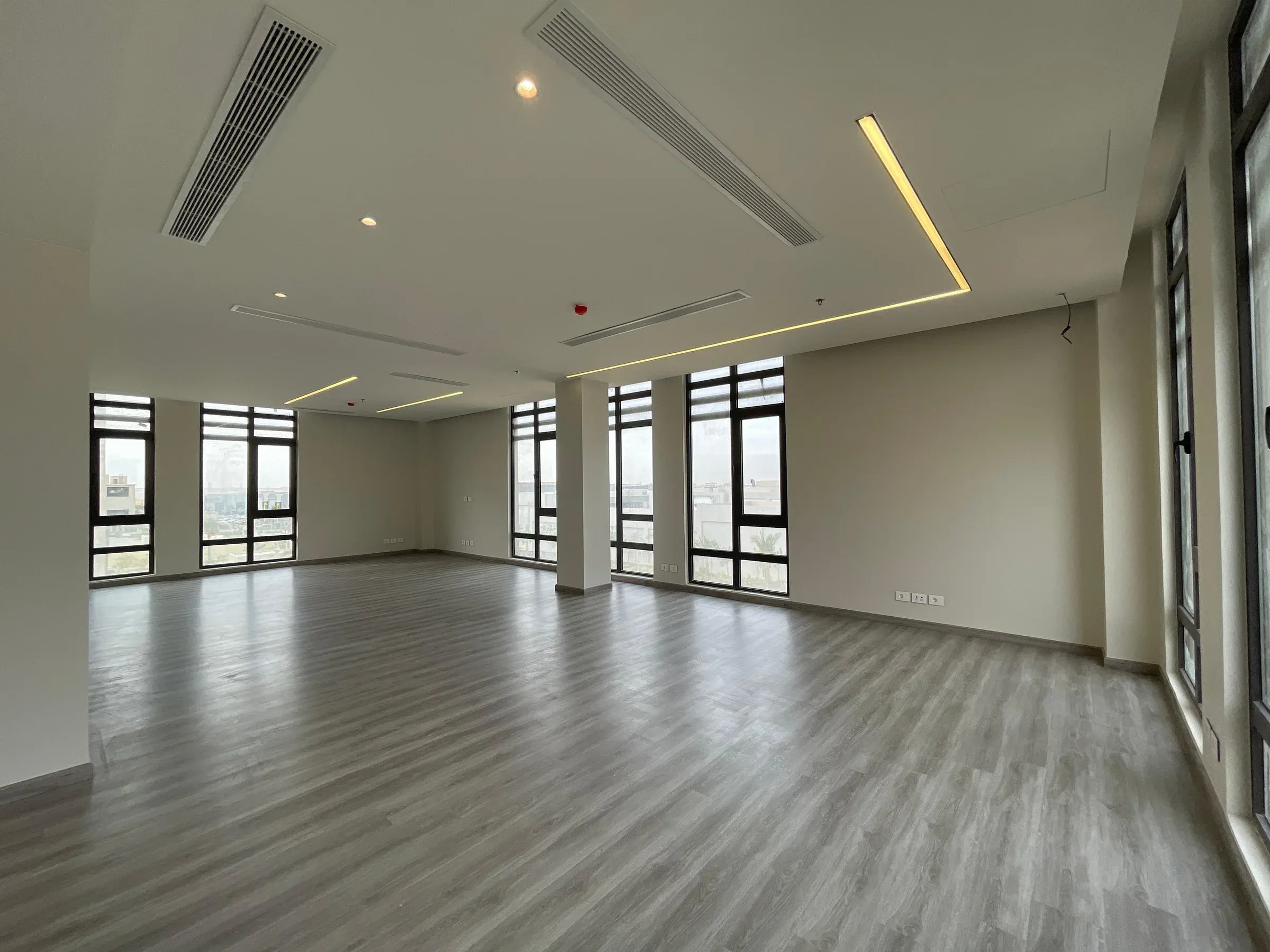 View towards the windows with a ceiling vent and L-shaped light line