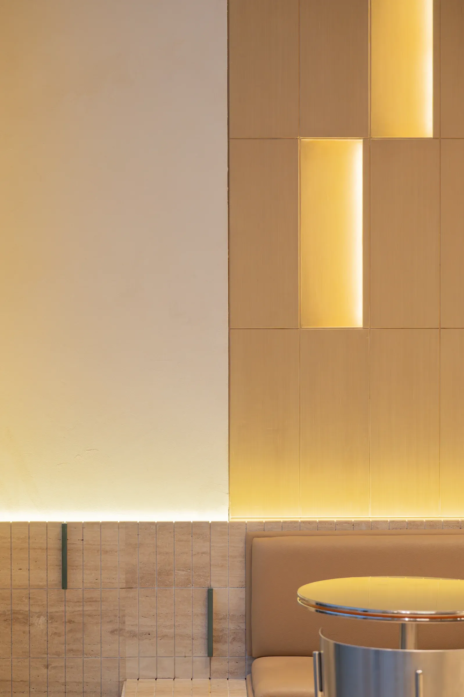 Detail of staggered lit slots in a pale timber wall