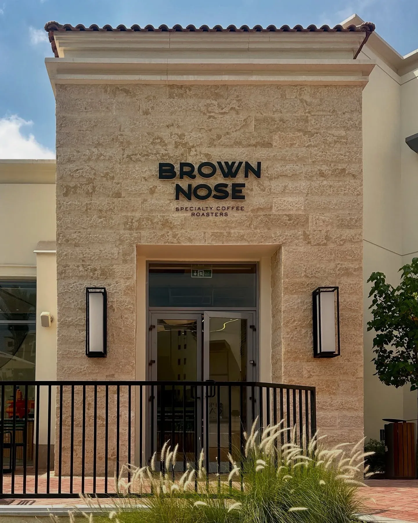Stone-clad entrance with Brown Nose sign above a black railing