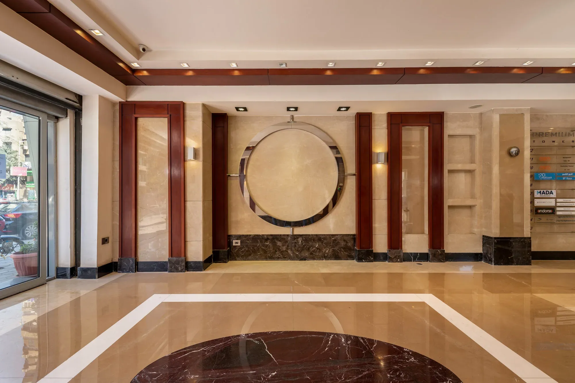 Lobby wall with a circular steel ring and timber pilasters