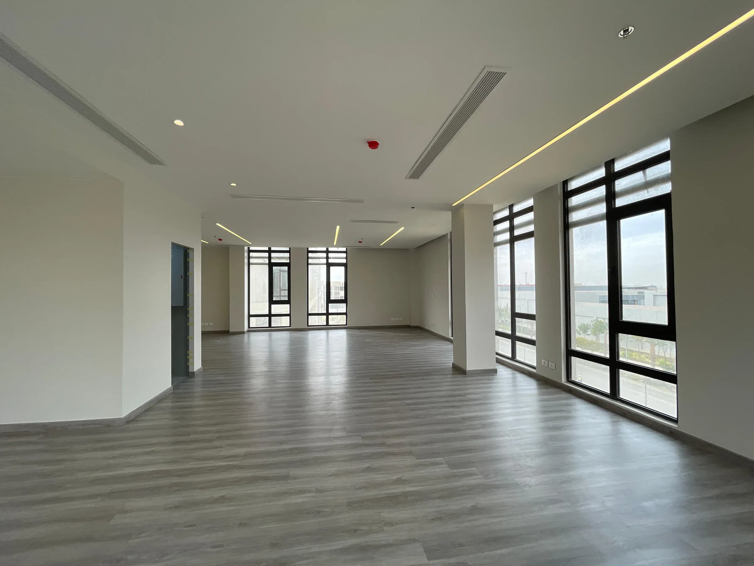 Large window on the right and a dark column across the open floor