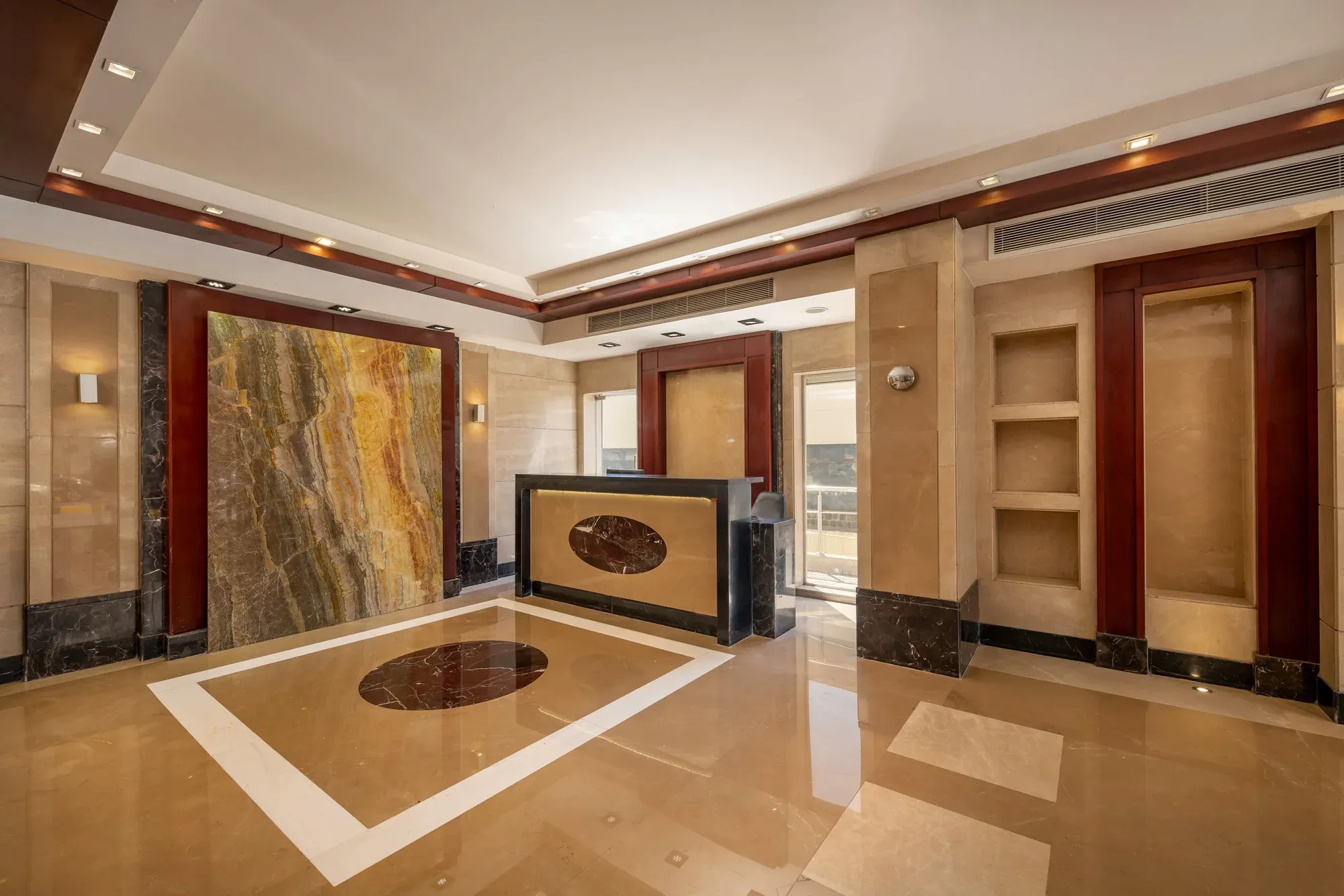Onyx feature panel beside reception, rectangular inlay in the floor