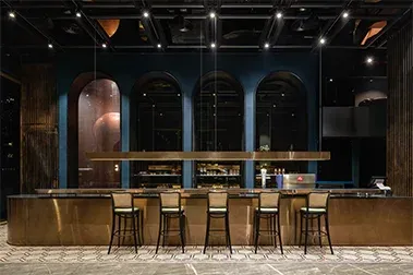 Wide view of the bar, blue arches and patterned tile floor