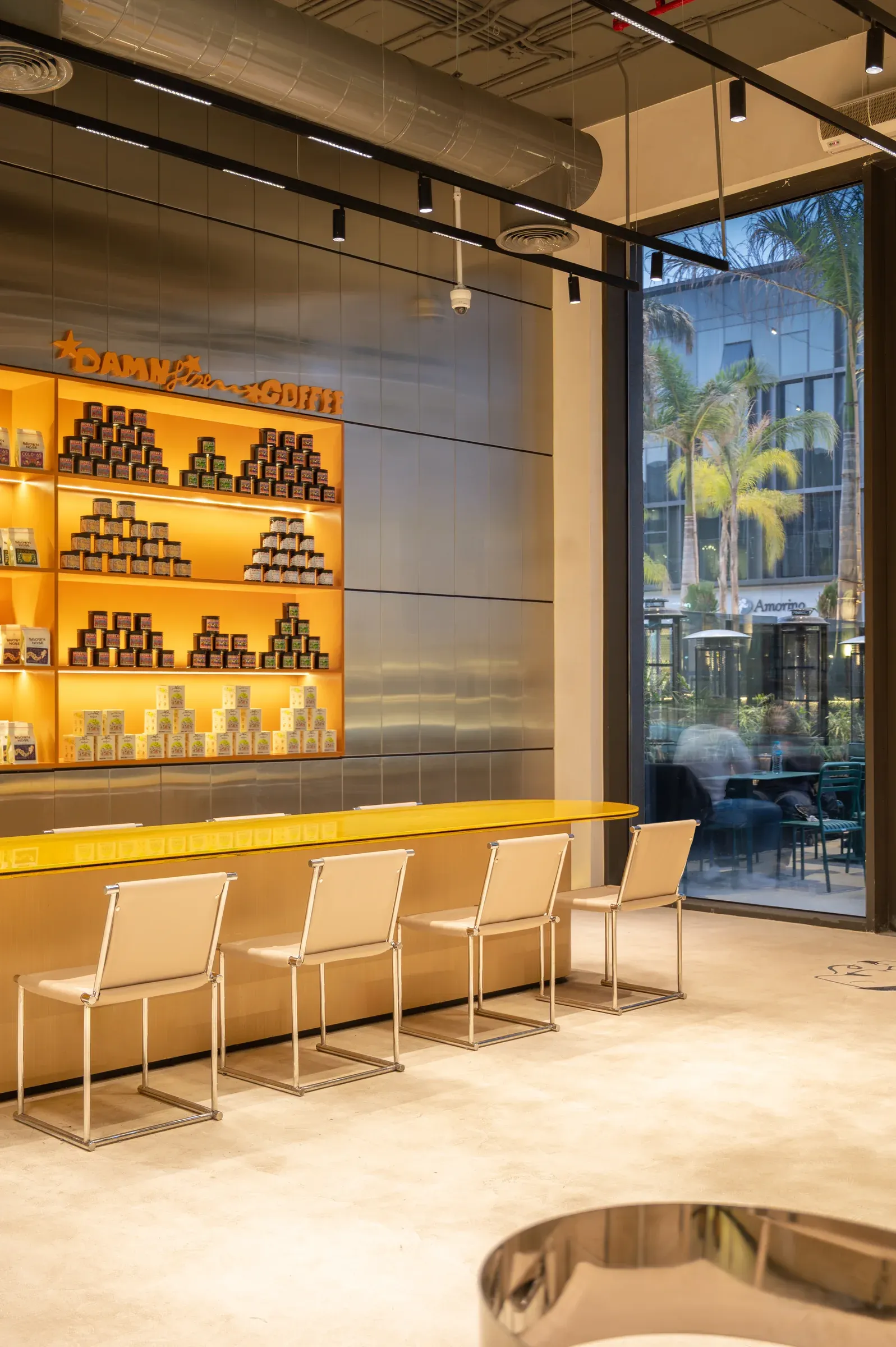 Seating beside the glass wall with palm trees outside