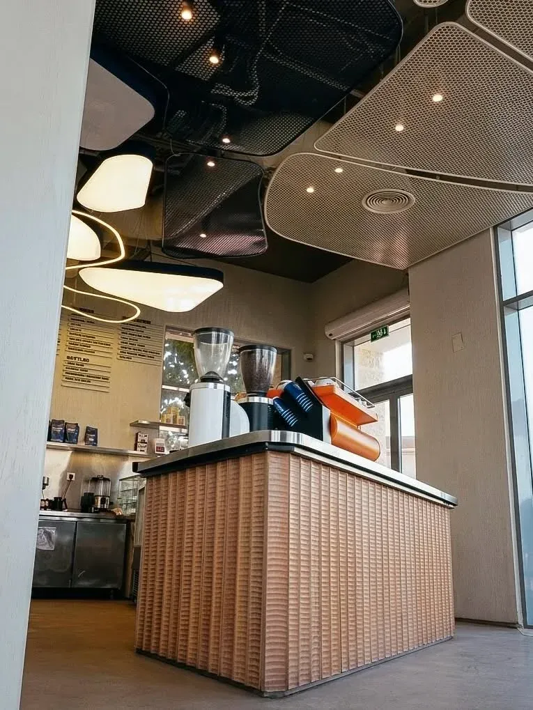 Ribbed counter with grinders seen from below the ceiling light pods