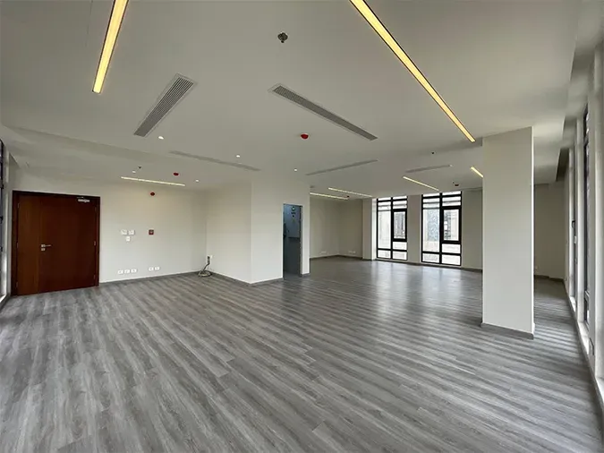 Timber door at left, column at right and linear ceiling lighting