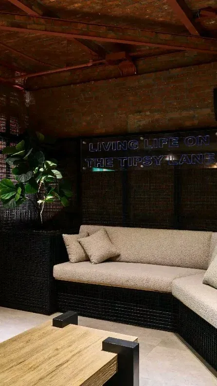 Corner sofa and low table in a dark lounge booth