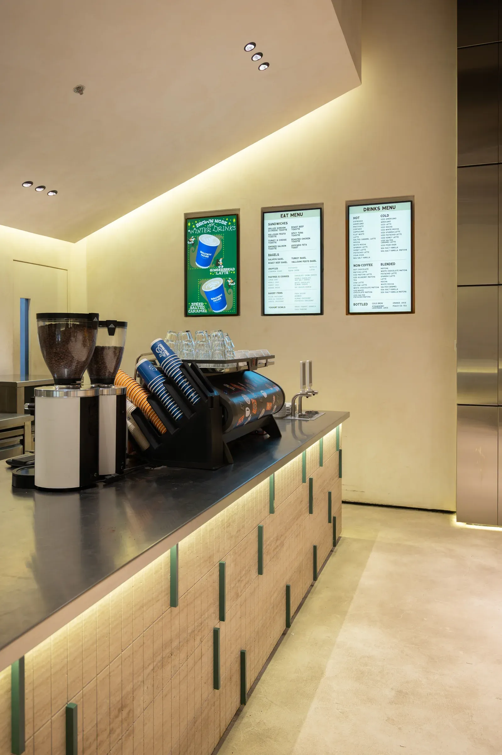 Coffee machine and grinder on a dark counter with stone-clad front