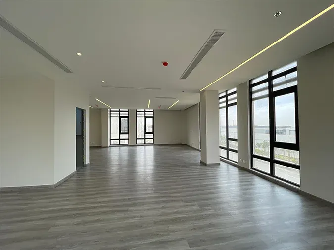 Corner view with a large window on the right and recessed spotlights