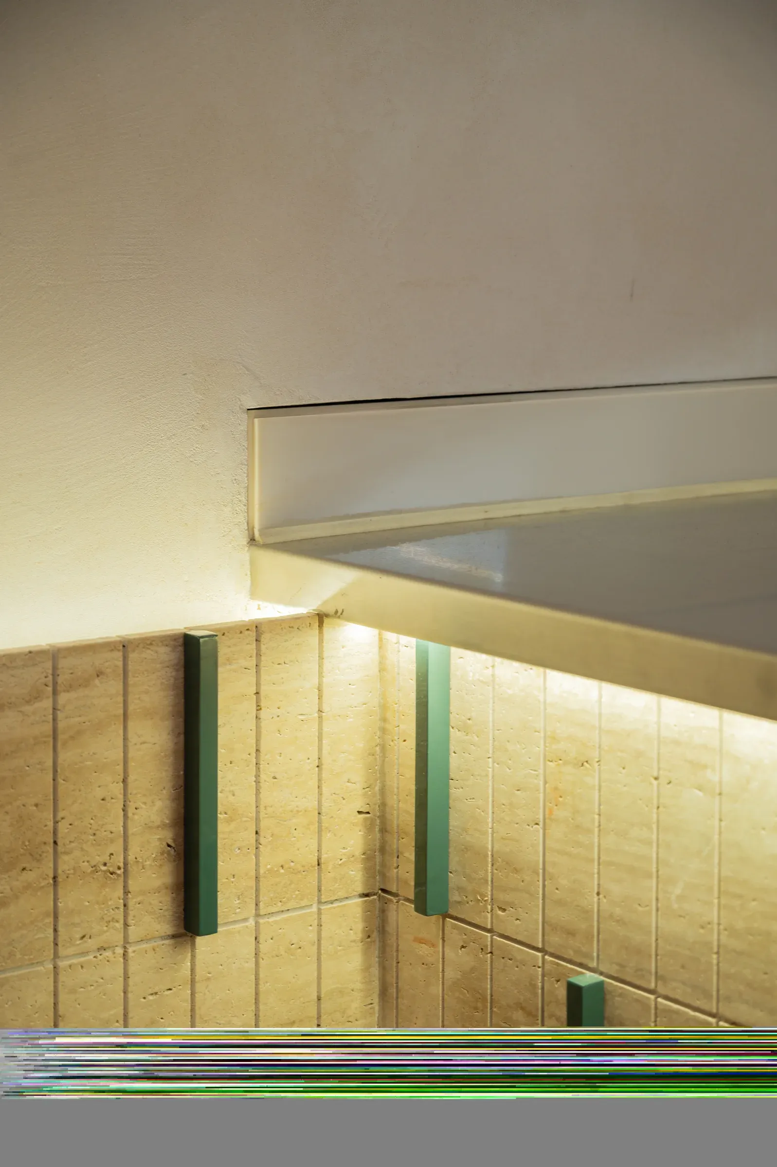 Stone-clad counter base with green strip lighting detail